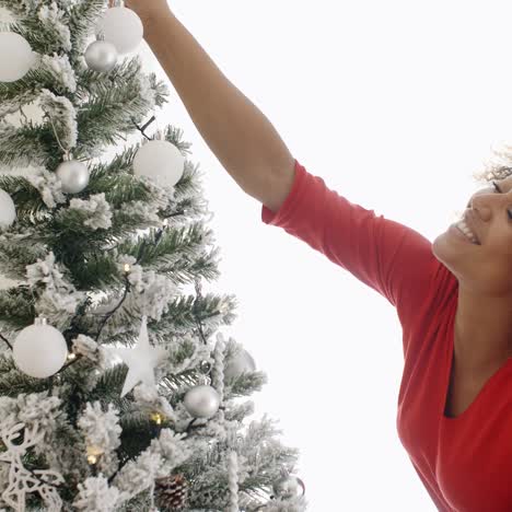 Attractive-woman-decorating-the-Xmas-tree