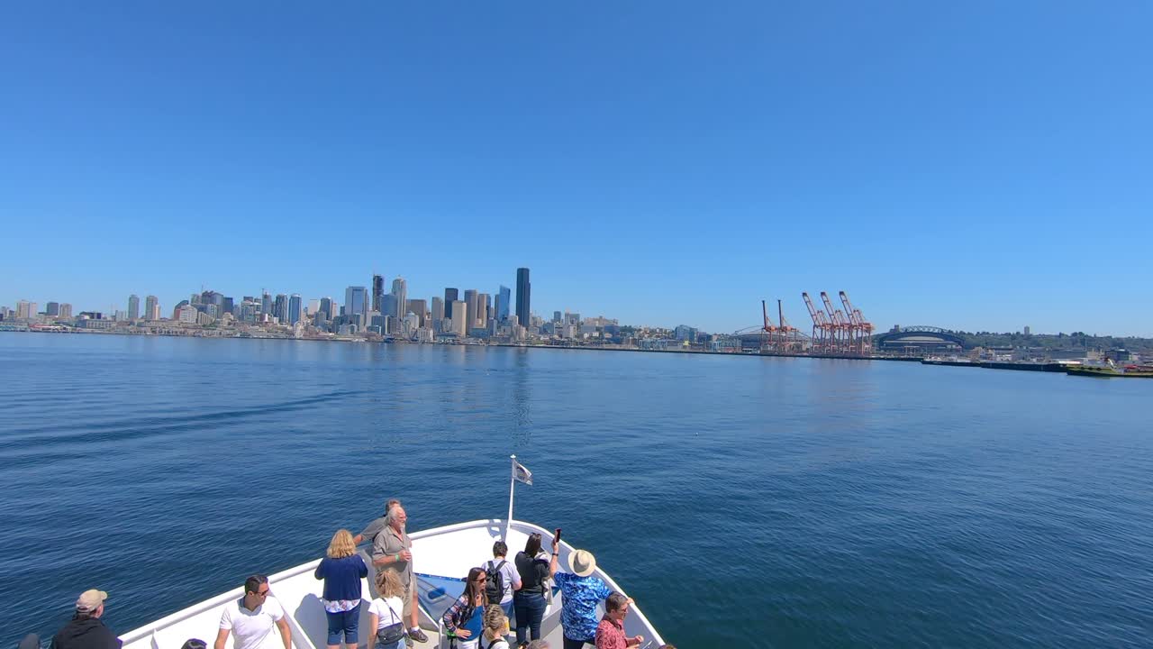 Sailing with a tourist boat on sunny summer day and coning close to the coast of Seattle city in USA