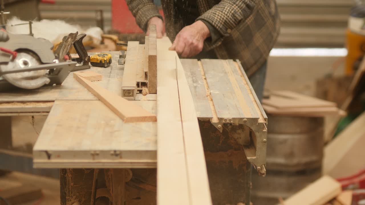 Tablesaw cutting wood planks for boat building project