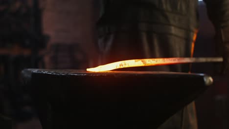 blacksmith at work, heating metal on an anvil