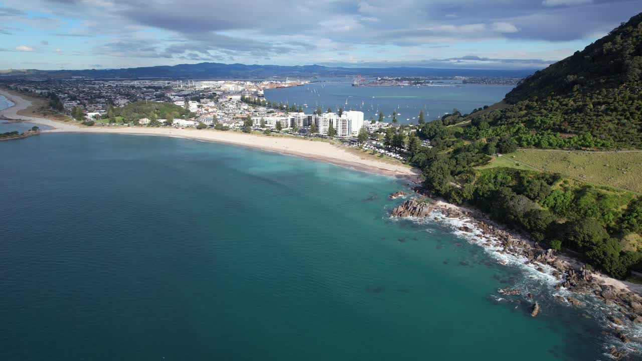 Aerial view of Mount Maunganui beach, coastline, and city with port in the distance