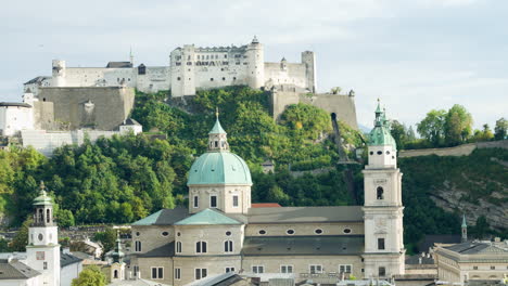 static shot of salzburg austria castle above hillside overlooking city center