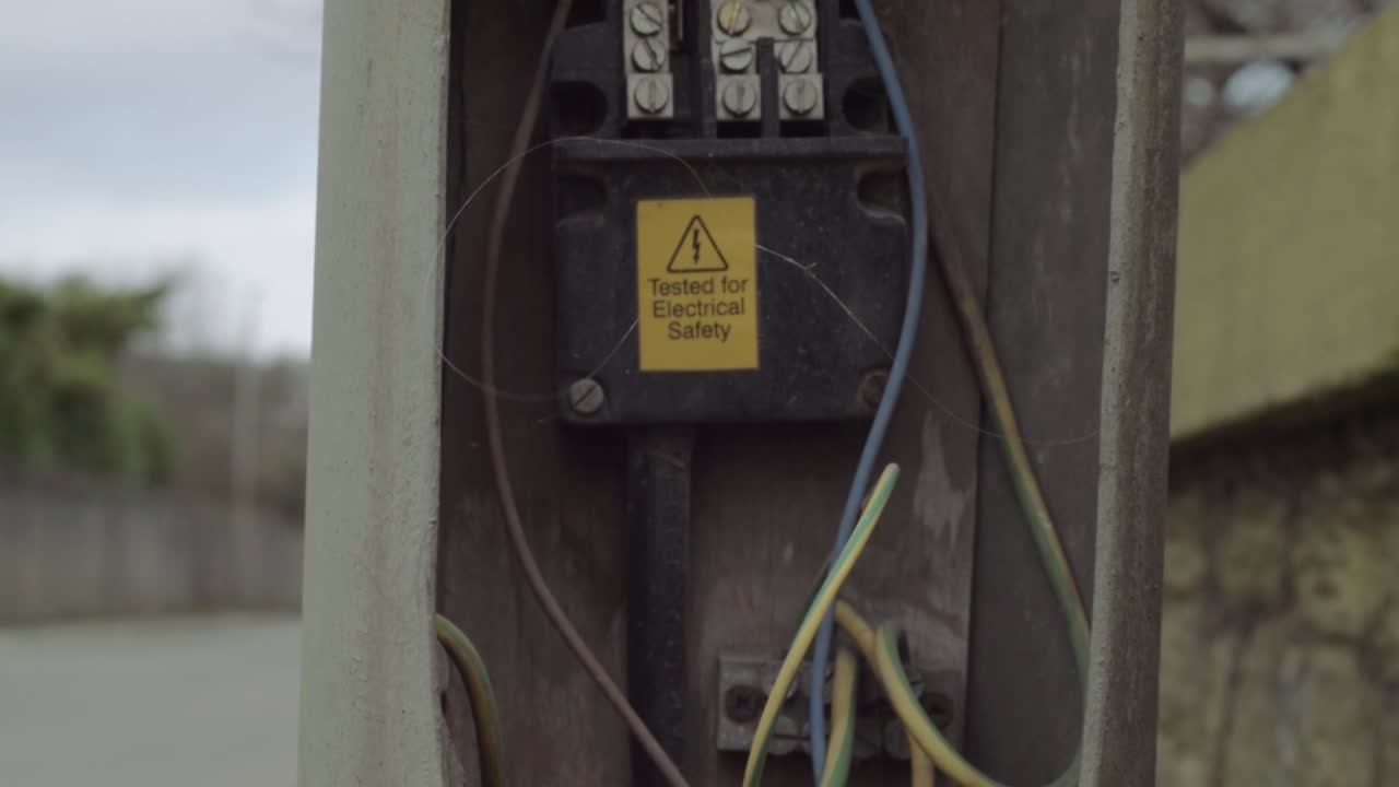 Broken street light left electrical fittings left open exposing electricity cables