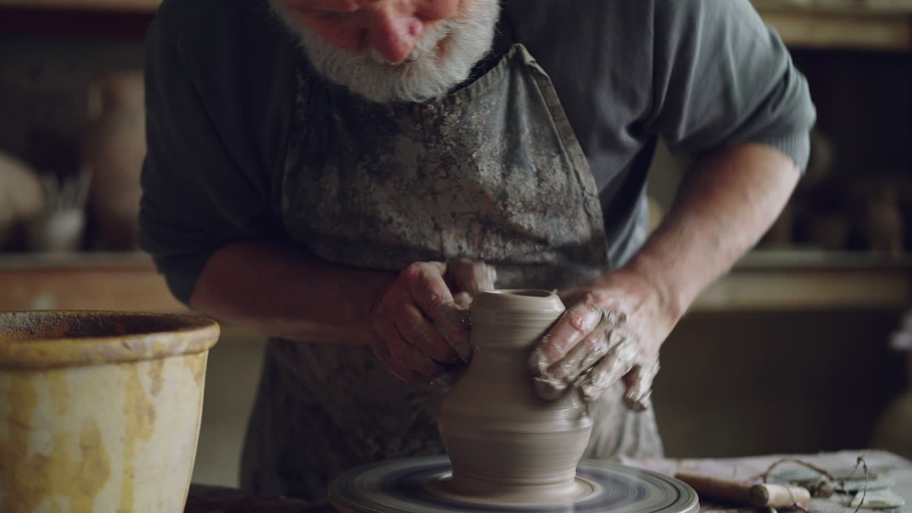 Old Man Potter Shaping Clay on Pottery Wheel