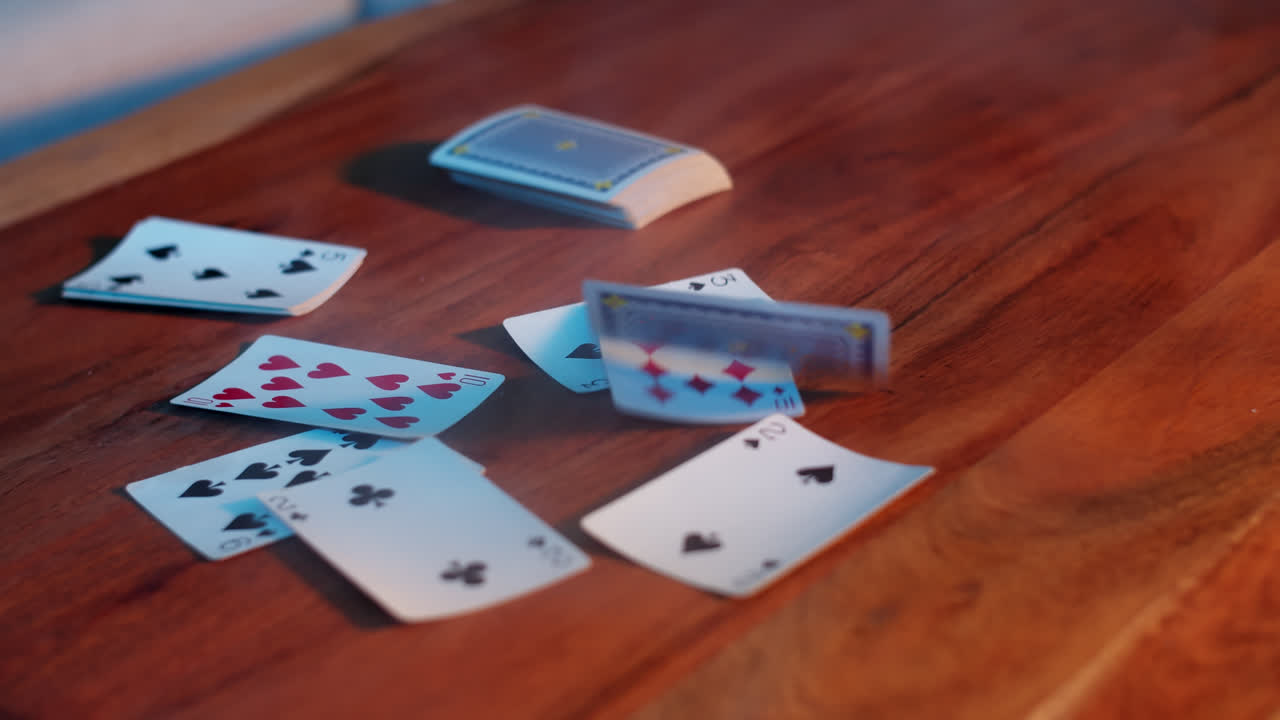 Scattered Playing Cards on a Wooden Table