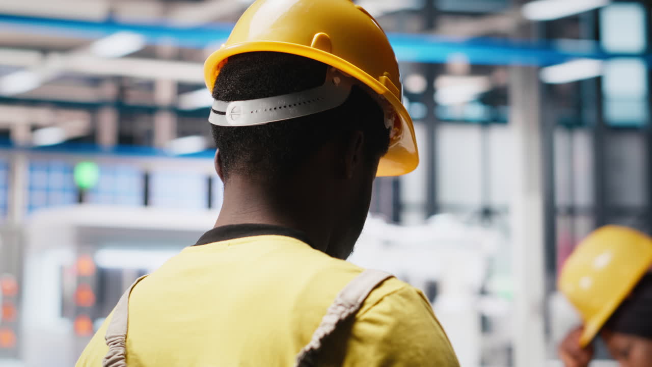 Photovoltaics factory worker uses tablet to improve solar panels manufacturing