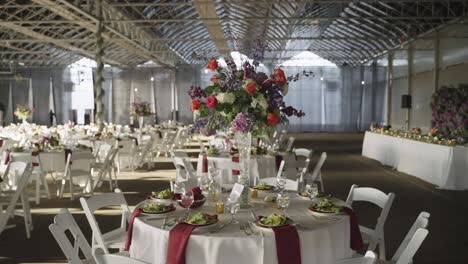 flower bouquet arrangement on a wedding banquet dining table in venue hall