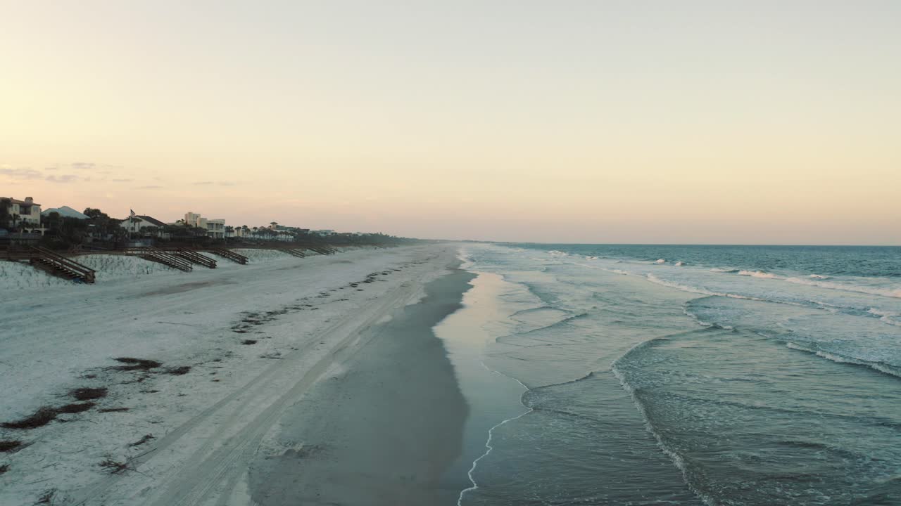 An empty shoreline with only the crashing waves present