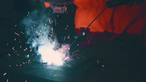 metal welder working with arc welding machine