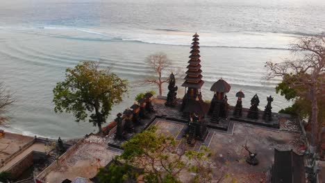 small temple at nusa penida island indonesia during sunrise, aerial