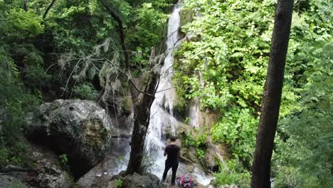 guy posing watching the waterfall falling