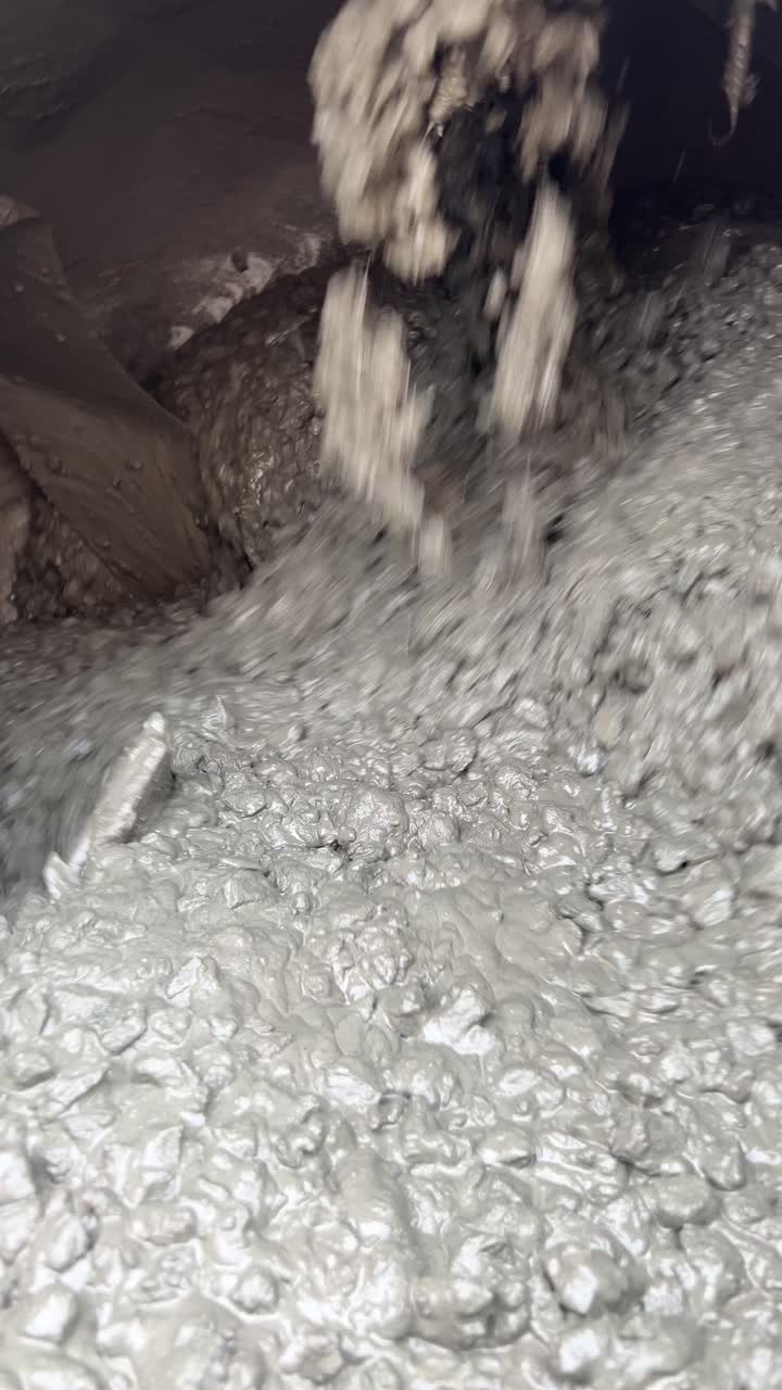 Process Of Making Fresh Concrete Mixture With A Portable Mixing Machine, Close Up Vertical Shot.