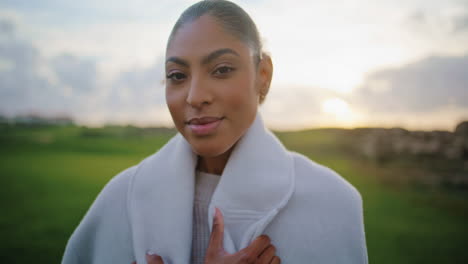 carefree black hair woman walk sunset field closeup. happy gorgeous model relax