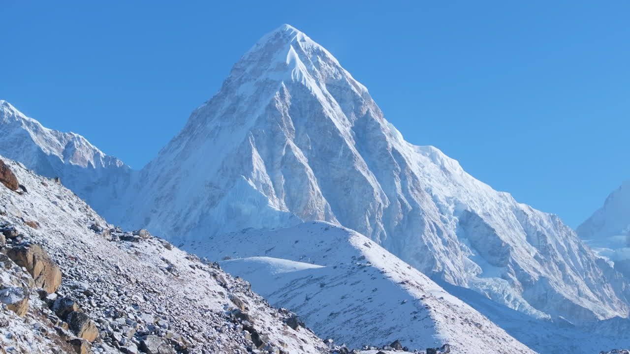 Drone captures peak over Everest Base Camp trek in Khumbu, Nepal. Morning sunshine rays reveal snow-capped 8000m Himalayan peaks, a breathtaking high-altitude scene of cold nature and majestic beauty