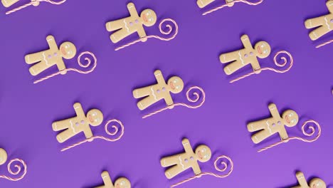 gingerbread men and candy canes on a purple background vertical