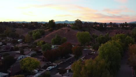 aerial drone rising over valencia hills in santa clarita, usa, with colorful sunset sky