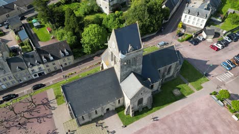 church in centre with paratrooper suspended from tower sainte mere eglise normandy france drone,aerial