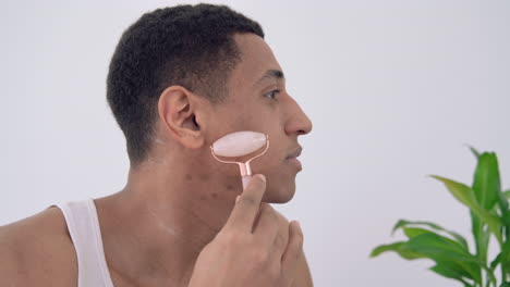 Portrait-Of-Black-Male-Using-Face-Massager-Roller-Sculpting-Tool