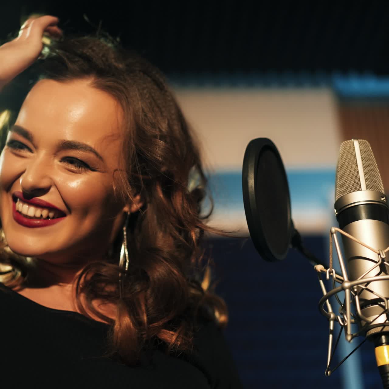 Beautiful young singer who recorded a song in a professional recording studio. Female vocal