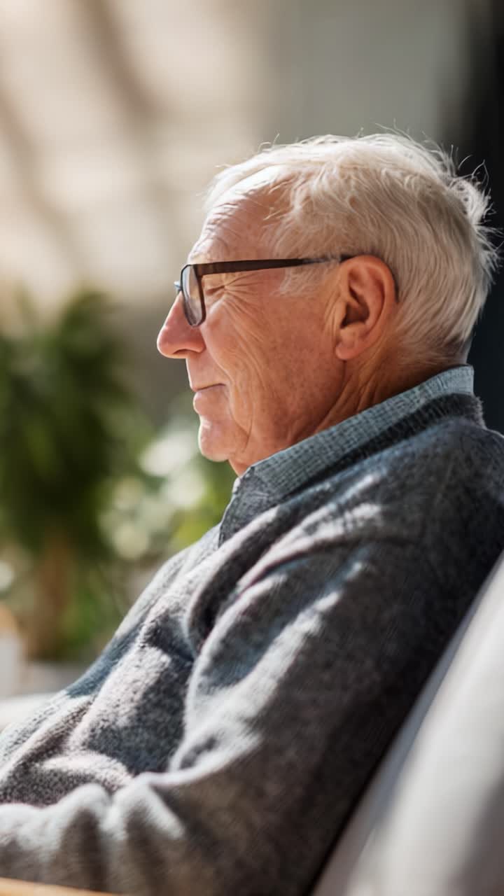 A Gentle Reflection: Capturing the Tranquil Expression of an Elderly Man Engaged in Contemplation Against a Bright, Natural Background