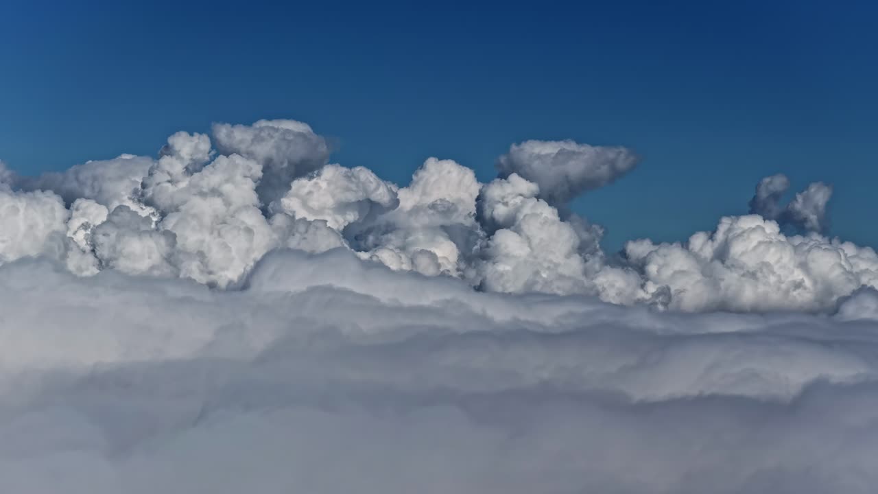 Cauliflower cumulus clouds skyline low altitude tall, dense, and vertical