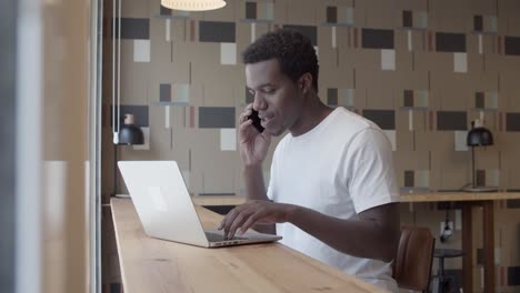 confident african american startup manager talking on phone