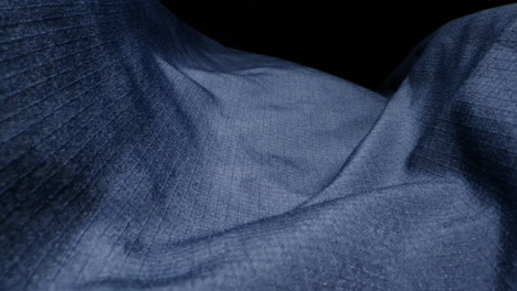 waterproof clothing for tourism. blue cloth texture with water drop close-up macro. repellent waterproof breathable fabrics. innovation waterproofing material test. high quality 4k footage