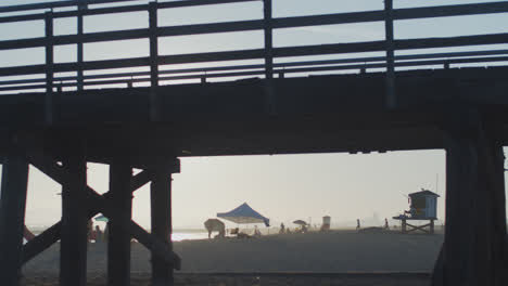 silhouette walkers on seal beach pier