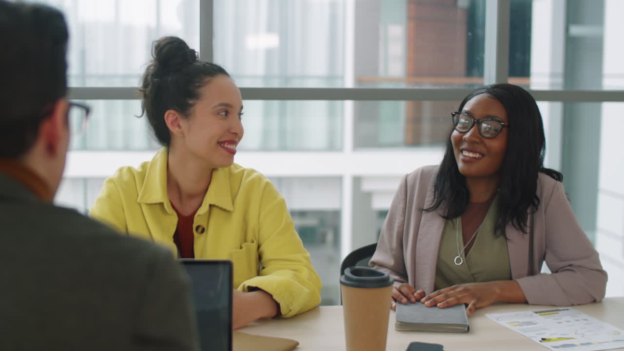 Multiethnic Coworkers Speaking at Business Meeting
