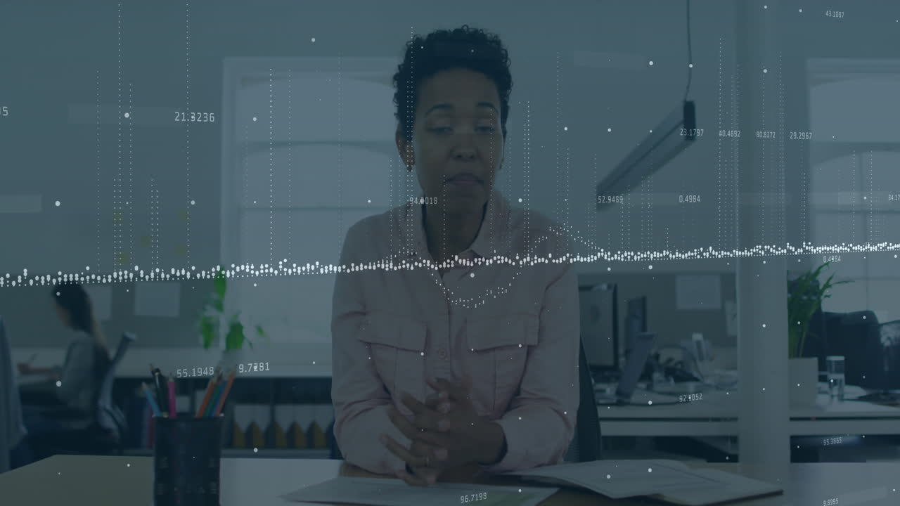Animation of graphs, changing numbers, african american woman talking on video call and waving hand