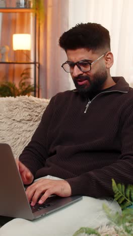 indian man closes laptop with frustration after facing internet problems at home angry gesture