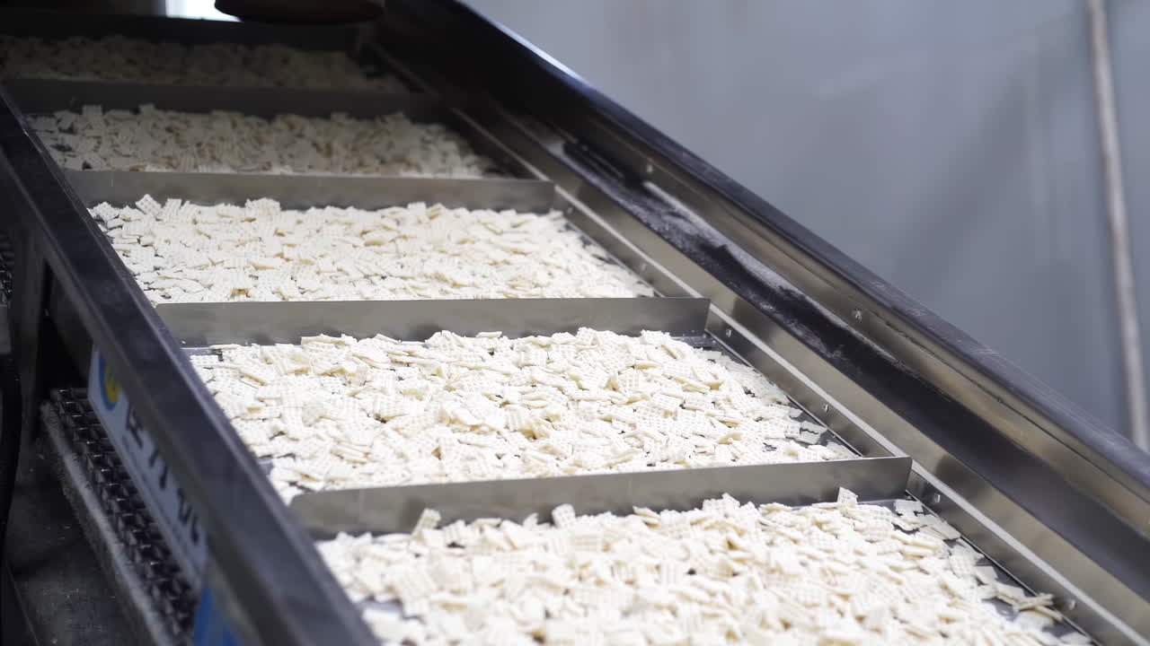 Cookie food cake factory on an assembly line, automated Cookies on a Conveyor Belt Production Line in a Factory, ready for packaging and distribution.
