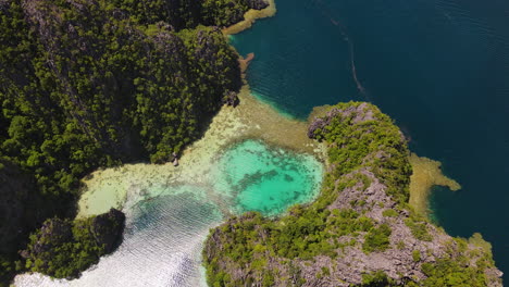 small lagoon at coron island on a sunny day in palawan, philippines. - aerial shot