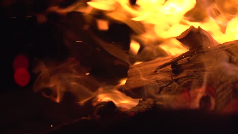 slow motion close-up on wood burning fire pit in the desert or woods while camping