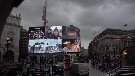 slow motion footage of piccadilly circus on a rainy day from a double decker bus.