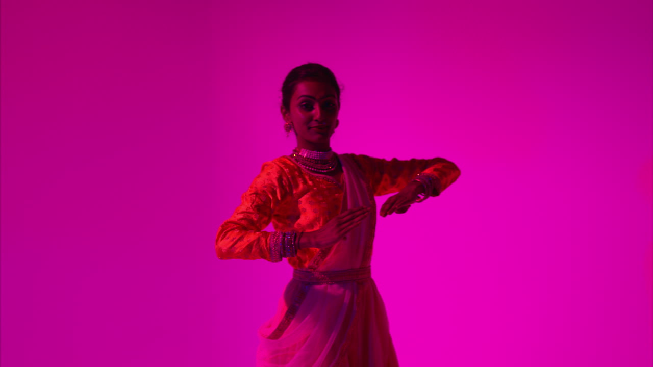 Waist Up Studio Shot Of Female Kathak Dancer Performing Dance Wearing Traditional Indian Dress Against Purple Background 2