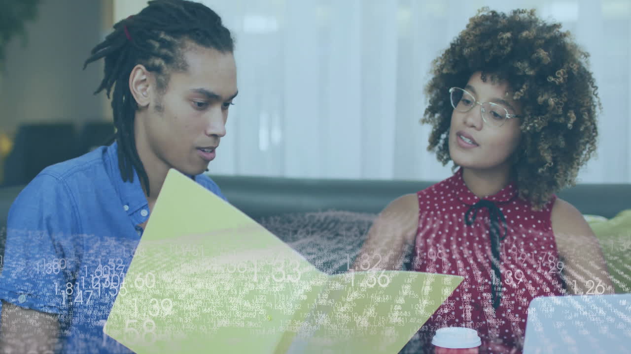 Discussing documents, two people with data processing animation overlay in office