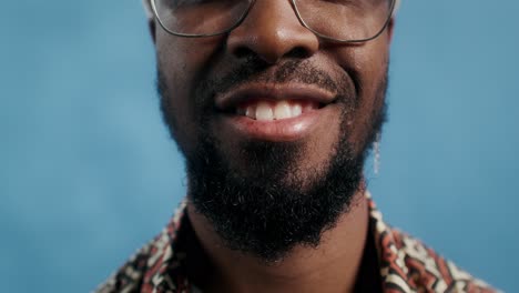 close-up portrait of a smiling man with beard and glasses