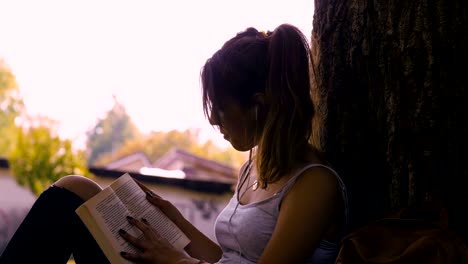 young student girl reading and listening to music