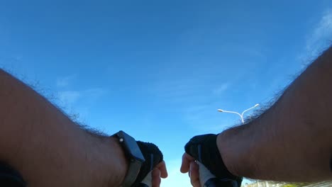 unique point of view of a cyclist's hands as he rides his bike