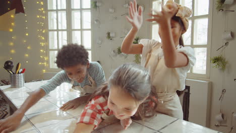 kids playing with flour in kitchen during cooking lesson