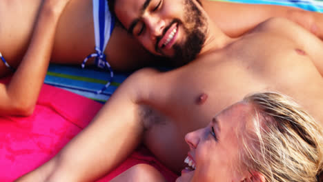 Group-of-friends-lying-on-towels