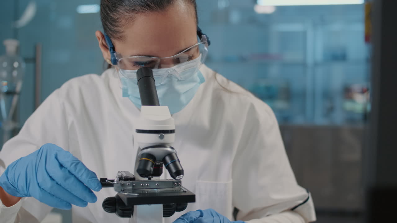 Specialist working with microscope in science laboratory