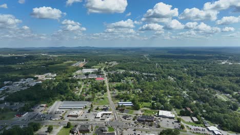 aerial lateral wide shot of american highway and green forest landscape in summer