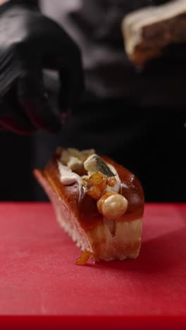 chef preparing a gourmet hot dog