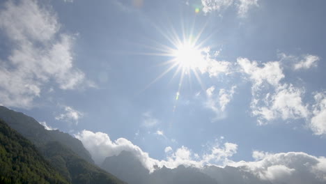 panoramic view in logarska valley, slovenia, green meadows with forest and high mountains in background, pan up