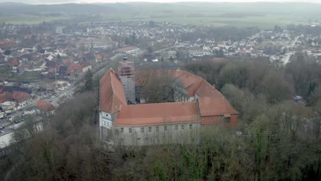 drone aerial view of the traditional german village herzberg am harz in the famous national park in central germany on a cloudy day in winter.