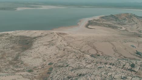 Aerial-Over-Arid-Coastline-Next-To-Salt-Lake-In-Karachi,-Pakistan