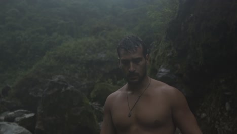 a man with a beard and wet hair is captured in a natural, candid moment walking on the quebrada gata trail