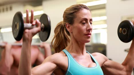 two fit people working out at crossfit session